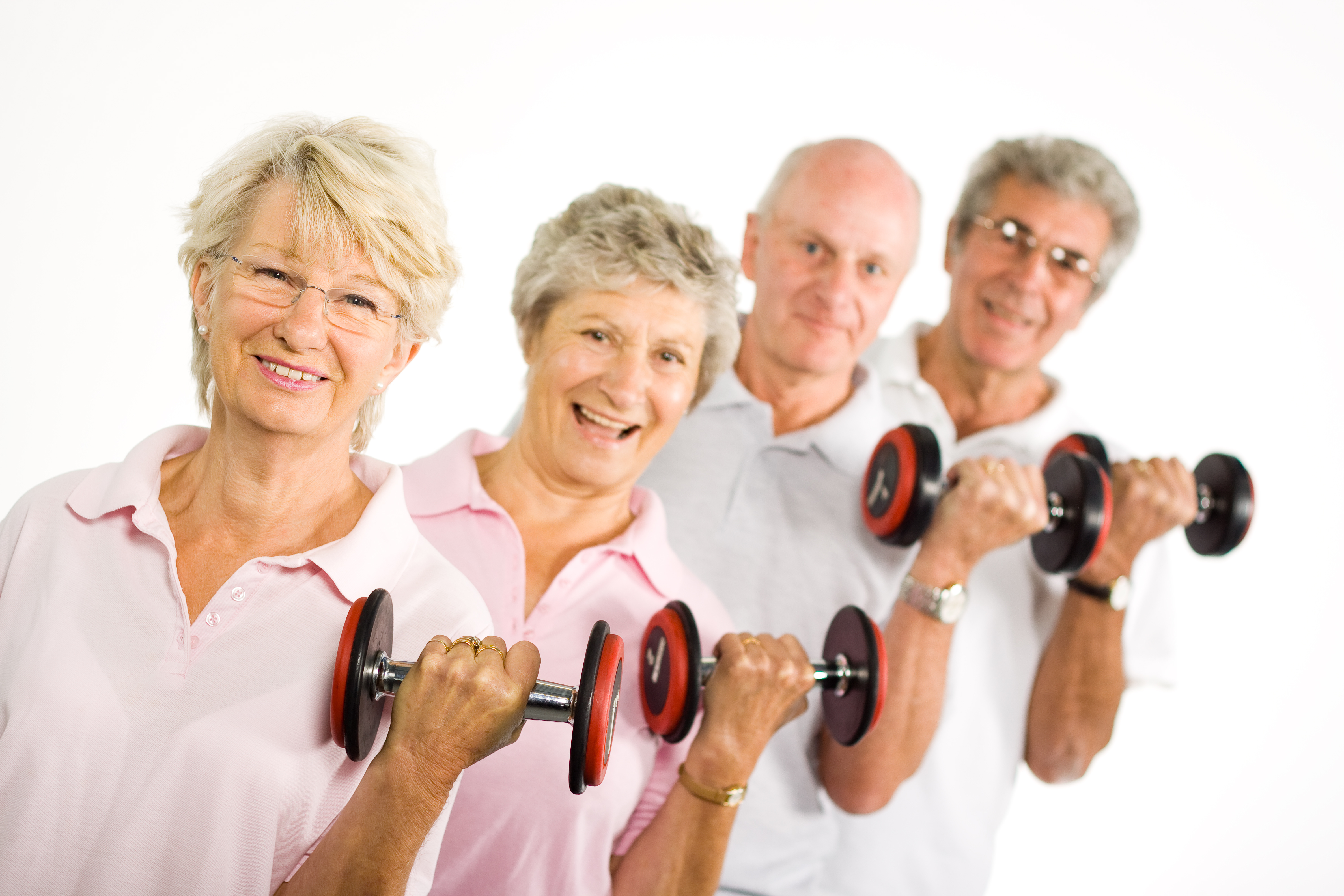 Group of older mature people lifting weights in the gym